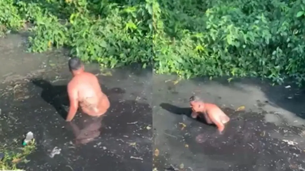 Homem pula em vala de esgoto para resgatar celular que custa R$ 6 mil (foto: Twitter/Reprodução)